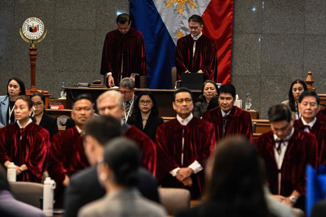 Philippine Senators, acting judges of the impeachment court, pray at the impeachment trial of Philippine Vice President Sara Duterte at the Senate of the Philippines in Pasay, Metro Manila on July 7, 2026. (Photo by NOEL CELIS / POOL / AFP)