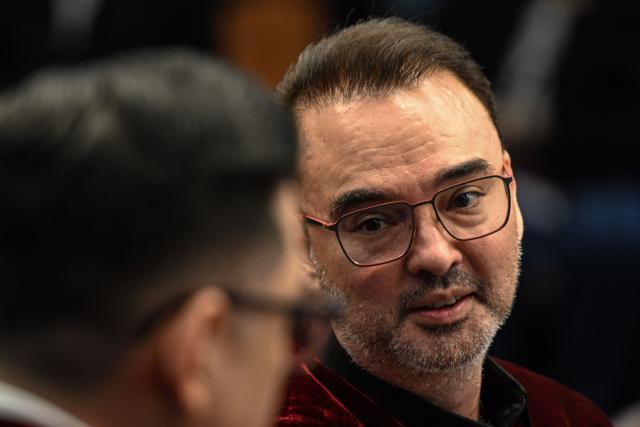 Philippine Senator Alan Peter Cayetano talks to a fellow senator during the impeachment trial of Philippine Vice President Sara Duterte at the Senate of the Philippines in Pasay, Metro Manila on July 7, 2026. (Photo by NOEL CELIS / POOL / AFP)