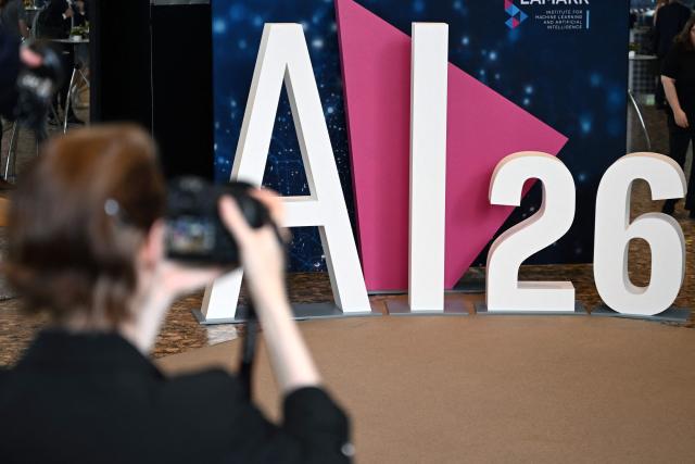 A photographer takes a photo of the Lamarr Conference at the World Conference Centre in Bonn, western Germany, on July 7, 2026. The Lamarr Conference is an international conference on artificial intelligence running from July 7-8 and bringing together "those shaping scientific foundations and those translating AI advances into tangible impact". In recognition of his achievements in AI research, development and knowledge transfer, the 2026 Lamarr Award will be presented to Jaroslaw Kutylowski, CEO and founder of German AI research company DeepL known for its language AI platform including DeepL Translator and for DeepL Agent. (Photo by Ina FASSBENDER / AFP)