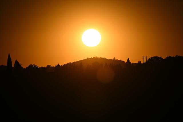 The sun rises over the town of Quillan, southern France, on July 7, 2026. (Photo by Lionel BONAVENTURE / AFP)