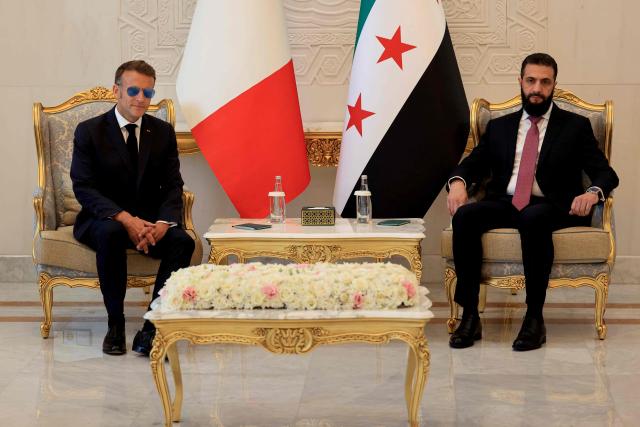 France's President Emmanuel Macron (L) and Syria's President Ahmed al-Sharaa attend a meeting at the People's Palace in Damascus on July 7, 2026. Syria's President Ahmed al-Sharaa hailed France's "constructive role" in the transition since the toppling of longtime ruler Bashar al-Assad, as French leader Emmanuel Macron made the first post-conflict visit to Damascus by a Western European leader. (Photo by Ludovic MARIN / POOL / AFP)
