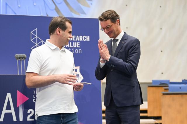 North Rhine-Westphalia's State Premier Hendrik Wuest (R) awards Jaroslaw Kutylowski, CEO and founder of German AI research company DeepL known for its language AI platform including DeepL Translator and for DeepL Agent, with the Lamarr Award during the Lamarr Conference at the World Conference Centre in Bonn, western Germany, on July 7, 2026. The Lamarr Conference is an international conference on artificial intelligence running from July 7-8 and bringing together "those shaping scientific foundations and those translating AI advances into tangible impact". In recognition of his achievements in AI research, development and knowledge transfer, the 2026 Lamarr Award will be presented to Jaroslaw Kutylowski. (Photo by Ina FASSBENDER / AFP)