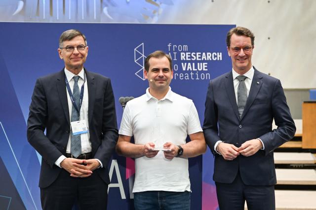 Stefan Wrobel (L), director of Lamarr Institute and North Rhine-Westphalia's State Premier Hendrik Wuest (R) pose with Jaroslaw Kutylowski, CEO and founder of German AI research company DeepL known for its language AI platform including DeepL Translator and for DeepL Agent, after he was presented the Lamarr Award during the Lamarr Conference at the World Conference Centre in Bonn, western Germany, on July 7, 2026. The Lamarr Conference is an international conference on artificial intelligence running from July 7-8 and bringing together "those shaping scientific foundations and those translating AI advances into tangible impact". In recognition of his achievements in AI research, development and knowledge transfer, the 2026 Lamarr Award will be presented to Jaroslaw Kutylowski. (Photo by Ina FASSBENDER / AFP)