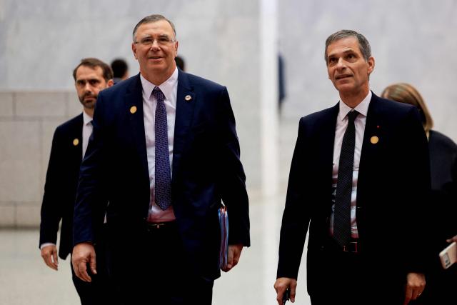Members of France's presidential delegation, TotalEnergies CEO Patrick Pouyanne (L) and CMA CGM Group Chairman and CEO Rodolphe Saade arrive at the Syrian presidential People's Palace ahead of France's President's and Syria's President's meeting in Damascus on July 7, 2026. Syria's President Ahmed al-Sharaa hailed France's "constructive role" in the transition since the toppling of longtime ruler Bashar al-Assad, as French leader Emmanuel Macron made the first post-conflict visit to Damascus by a Western European leader. (Photo by Ludovic MARIN / POOL / AFP)