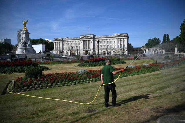 A groundskeeper waters the grass and flowers in Memorial Gardens, on thedge of Green Park, near Buckingham Palace, in central London on July 7, 2026, during a heatwave. (Photo by JUSTIN TALLIS / AFP)