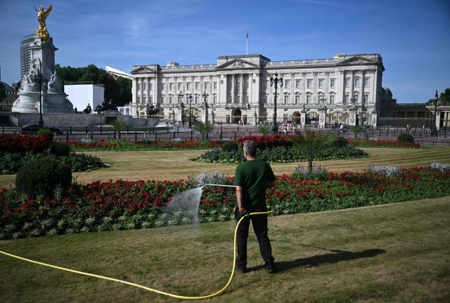 A groundskeeper waters the grass and flowers in Memorial Gardens, on thedge of Green Park, near Buckingham Palace, in central London on July 7, 2026, during a heatwave. (Photo by JUSTIN TALLIS / AFP)