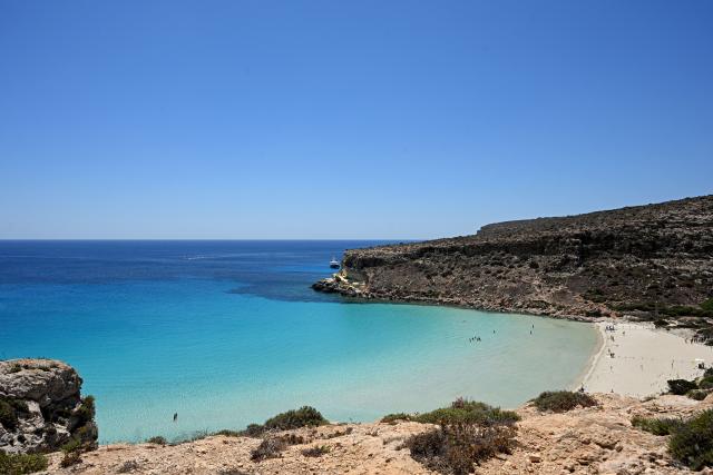 This photograph shows the rabbit Beach in the Italian island of Lampedusa, a protected nature reserve with limited daily visitor access to avoid over tourism, on July 6, 2026. (Photo by Tiziana FABI / AFP)