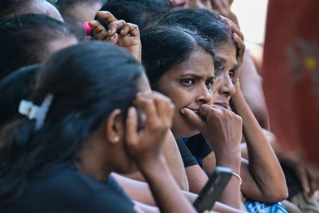 Relatives of victims killed in clashes between inmates of two drug gangs, grieve in front of the Negombo prison on the outskirts of Colombo on July 7, 2026. Clashes in a Sri Lankan jail have killed 23 people, including four guards, and wounded more than 100 in the country's deadliest prison riot in more than five years, officials said on July 6. (Photo by Ishara S. KODIKARA / AFP)