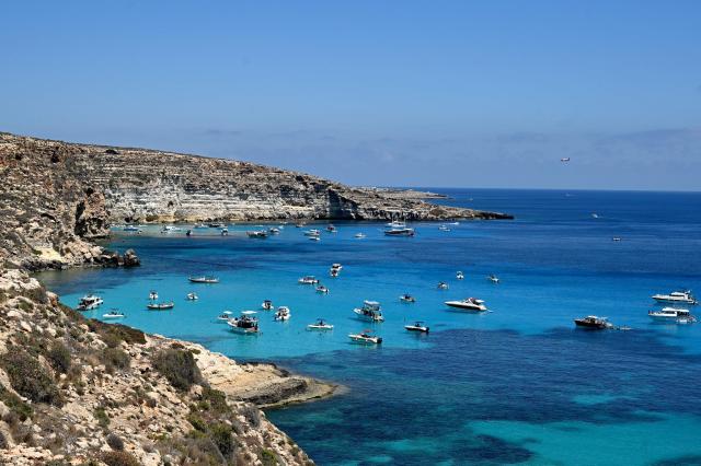 This photograph shows boats anchored at Cala Tabaccara cove in the Italian island of Lampedusa on July 6, 2026. (Photo by Tiziana FABI / AFP)