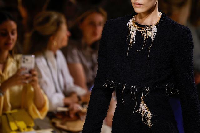 A model presents a creation for Chanel for the Women Haute Couture Fall/Winter 2026-2027 collection as part of the Paris Fashion Week, in Paris, on July 7, 2026. (Photo by GEOFFROY VAN DER HASSELT / AFP)