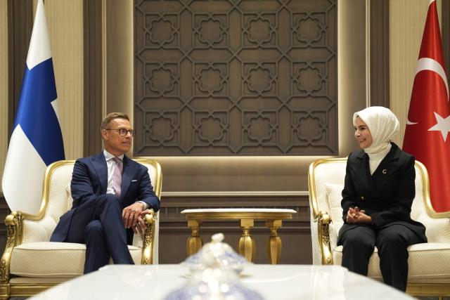 Finland's President Alexander Stubb (L) meets with Turkey's Minister of Family and Social Services Mahinur Ozdemir Goktas (R) upon arrival at Esenboga Airport to attend the 36th NATO Heads of State and Government Summit in Ankara on July 7, 2026. (Photo by Osmancan Gürdo?an / POOL / AFP)