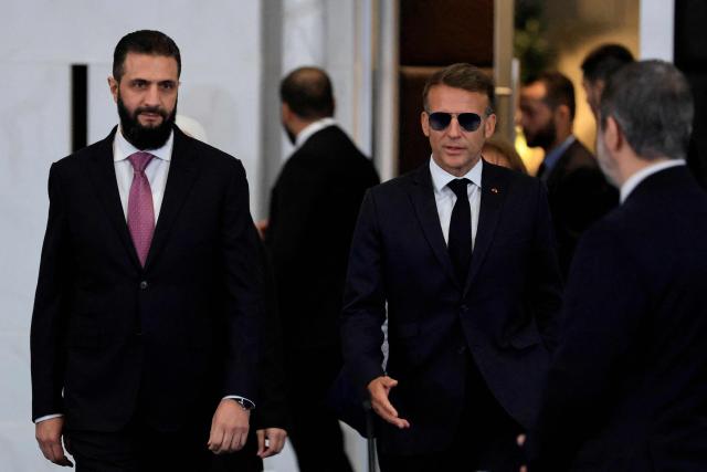 France's President Emmanuel Macron (R) and Syria's President  Ahmed al-Sharaa arrive to take part in the Economic forum focusing on the reconstruction of Syria and strategic corridors, in Damascus on July 7, 2026. Syria's President Ahmed al-Sharaa hailed France's "constructive role" in the transition since the toppling of longtime ruler Bashar al-Assad, as French leader Emmanuel Macron made the first post-conflict visit to Damascus by a Western European leader. (Photo by Ludovic MARIN / POOL / AFP)