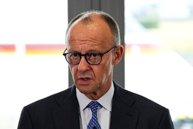 German Chancellor Friedrich Merz addresses journalists before his flight from Berlin-Schoenefeld airport to Ankara, Turkey, where he is expected to attend the 36th NATO Heads of State and Government Summit, on July 7, 2026. (Photo by John MACDOUGALL / AFP)