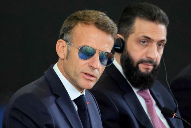 France's President Emmanuel Macron (L) and Syria's President Ahmed al-Sharaa take part in the Economic forum focusing on the reconstruction of Syria and strategic corridors, in Damascus on July 7, 2026. Syria's President Ahmed al-Sharaa hailed France's "constructive role" in the transition since the toppling of longtime ruler Bashar al-Assad, as French leader Emmanuel Macron made the first post-conflict visit to Damascus by a Western European leader. (Photo by Ludovic MARIN / POOL / AFP)