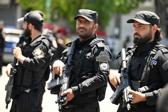 Security personnel stand guard near the Four Seasons Hotel following two blasts nearby in Damascus on July 7, 2026. Two explosions shook Damascus on July 7 near a hotel where French President Emmanuel Macron was staying, wounding at least 18 people, during the French leader's landmark visit to Syria. (Photo by LOUAI BESHARA / AFP)