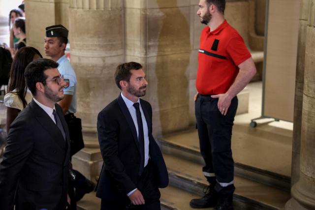 Rassemblement National's MP Julien Odoul (C) arrives to attend the verdict in the appeal trial of RN former or actual members on charges of embezzlement of European public funds in a case of alleged European Parliament fake jobs at Paris Court of Appeal on July 7, 2026. A lower court last year sentenced longtime party leader and three-time presidential candidate, Marine Le Pen, to a five-year ban from public office and two years in prison over a fake jobs scam at the European Parliament. The appeals court will rule on whether to uphold the ban in a case that has upended her presidential aspirations. (Photo by Kenzo TRIBOUILLARD / AFP)