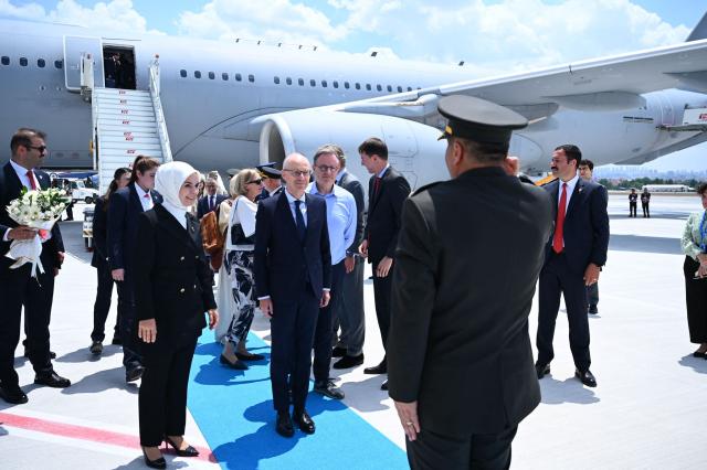 Belgium's Prime Minister Bart De Wever (C) and Luxembourg's Prime Minister Luc Frieden are welcomed by Turkey's Minister of Family and Social Services Mahinur Ozdemir Goktas (L) upon arrival at Esenboga Airport to attend the 36th NATO Heads of State and Government Summit in Ankara on July 7, 2026. (Photo by Abdullah Güçlü / POOL / AFP)
