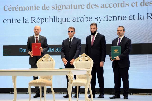 (From L) France's Foreign Affairs Minister Jean-Noel Barrot, France's President Emmanuel Macron, Syria's interim president Ahmed al-Sharaa and Syria's Foreign Minister Asaad al-Shaibani pose after signing a Framework Agreement on Bilateral Cooperation an agreement signing ceremony in Damascus on July 7, 2026. French President Emmanuel Macron arrived in Damascus on July 6, 2026 for the first visit by a Western European head of state since Syria's new authorities took power in 2024, an AFP journalist said. Macron, who will depart on July 7, 2026, will advocate for "a free, pluralist Syria that respects each of its components" and plays a role in moderating Middle East tensions, the French presidency told journalists ahead of his arrival. (Photo by Ludovic MARIN / POOL / AFP)