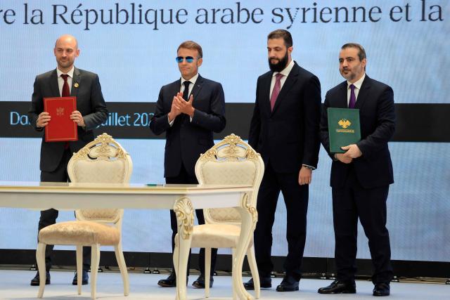 (From L) France's Foreign Affairs Minister Jean-Noel Barrot, France's President Emmanuel Macron, Syria's interim president Ahmed al-Sharaa and Syria's Foreign Minister Asaad al-Shaibani pose after signing a Framework Agreement on Bilateral Cooperation an agreement signing ceremony in Damascus on July 7, 2026. French President Emmanuel Macron arrived in Damascus on July 6, 2026 for the first visit by a Western European head of state since Syria's new authorities took power in 2024, an AFP journalist said. Macron, who will depart on July 7, 2026, will advocate for "a free, pluralist Syria that respects each of its components" and plays a role in moderating Middle East tensions, the French presidency told journalists ahead of his arrival. (Photo by Ludovic MARIN / POOL / AFP)