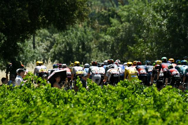 Spectators watch the pack during the 4th stage of the 113th edition of the Tour de France cycling race, 181,9 km between Carcassonne and Foix in southwestern France, on July 7, 2026. (Photo by Loic VENANCE / AFP)