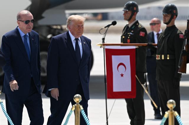 Turkish President Recep Tayyip Erdogan (L) welcomes US President Donald Trump (R) upon his arrival on Air Force One at Etimesgut Air Base near Ankara, on July 7, 2026, before attending the 36th NATO Heads of State and Government Summit. (Photo by Abdullah Güçlü / POOL / AFP)
