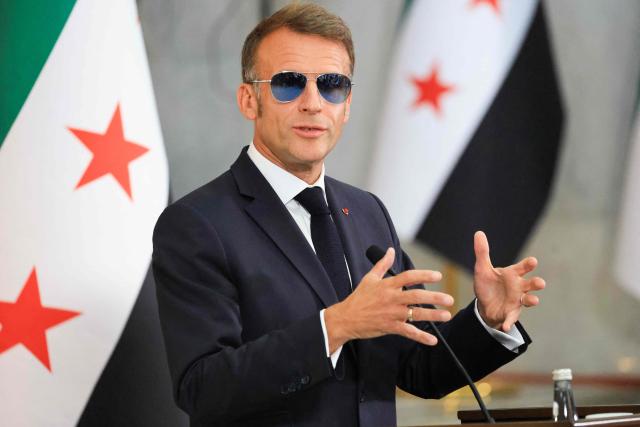 France's President Emmanuel Macron, wearing sunglasses, speaks during a joint press conference with Syrian President in Damascus on July 7, 2026. French President Emmanuel Macron arrived in Damascus on July 6, 2026 for the first visit by a Western European head of state since Syria's new authorities took power in 2024, an AFP journalist said. Macron, who will depart on July 7, 2026, will advocate for "a free, pluralist Syria that respects each of its components" and plays a role in moderating Middle East tensions, the French presidency told journalists ahead of his arrival. (Photo by Ludovic MARIN / POOL / AFP)
