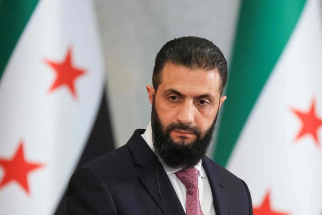 Syrian President Ahmed al-Sharaa looks on during a joint press conference with France's President in Damascus on July 7, 2026. French President Emmanuel Macron arrived in Damascus on July 6, 2026 for the first visit by a Western European head of state since Syria's new authorities took power in 2024, an AFP journalist said. Macron, who will depart on July 7, 2026, will advocate for "a free, pluralist Syria that respects each of its components" and plays a role in moderating Middle East tensions, the French presidency told journalists ahead of his arrival. (Photo by Ludovic MARIN / POOL / AFP)