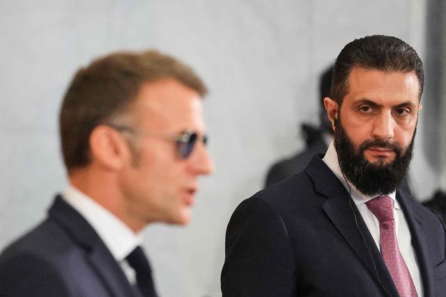 France's President Emmanuel Macron (L) and Syrian President Ahmed al-Sharaa give a joint press conference in Damascus on July 7, 2026. French President Emmanuel Macron arrived in Damascus on July 6, 2026 for the first visit by a Western European head of state since Syria's new authorities took power in 2024, an AFP journalist said. Macron, who will depart on July 7, 2026, will advocate for "a free, pluralist Syria that respects each of its components" and plays a role in moderating Middle East tensions, the French presidency told journalists ahead of his arrival. (Photo by Ludovic MARIN / POOL / AFP)