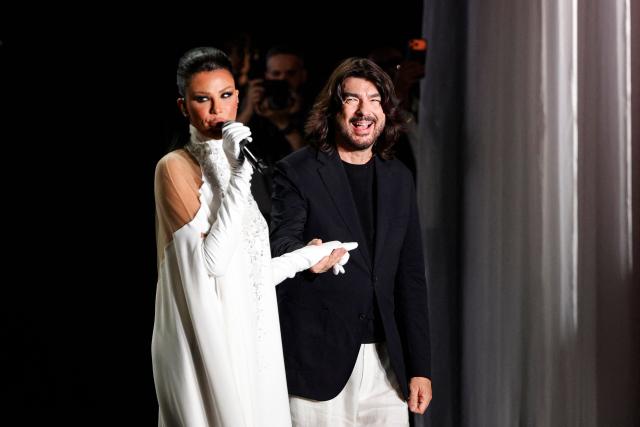 French fashion designer Stephan Rolland (C) acknowledges the audience at the end of the Stephane Rolland Women Haute Couture Fall/Winter 2026-2027 collection as part of the Paris Fashion Week, in Paris, on July 7, 2026. (Photo by GEOFFROY VAN DER HASSELT / AFP)