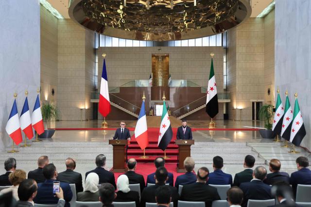 France's President Emmanuel Macron (C-L) and Syrian President Ahmed al-Sharaa (C-R) give a joint press conference in Damascus on July 7, 2026. French President Emmanuel Macron arrived in Damascus on July 6, 2026 for the first visit by a Western European head of state since Syria's new authorities took power in 2024, an AFP journalist said. Macron, who will depart on July 7, 2026, will advocate for "a free, pluralist Syria that respects each of its components" and plays a role in moderating Middle East tensions, the French presidency told journalists ahead of his arrival. (Photo by Ludovic MARIN / POOL / AFP)