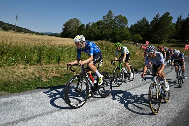 Movistar Team's Spanish rider Pablo Castrillo (L) rides with the chasing group during the 4th stage of the 113th edition of the Tour de France cycling race, 181,9 km between Carcassonne and Foix in southwestern France, on July 7, 2026. (Photo by Loic VENANCE / AFP)