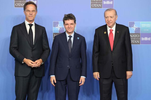 NATO Secretary General Mark Rutte (L) and Turkey's President Recep Tayyip Erdogan greet Romania's President Nicusor Dan as he arrives for a NATO Summit at Bestepe Presidential Compound in Ankara, Turkey, July 8, 2026. The summit comes at a fraught time for the 77-year-old transatlantic alliance, with the US President demanding members make good on a pledge to ramp up defence spending as Washington takes a step back from Europe. (Photo by Ludovic MARIN / POOL / AFP)