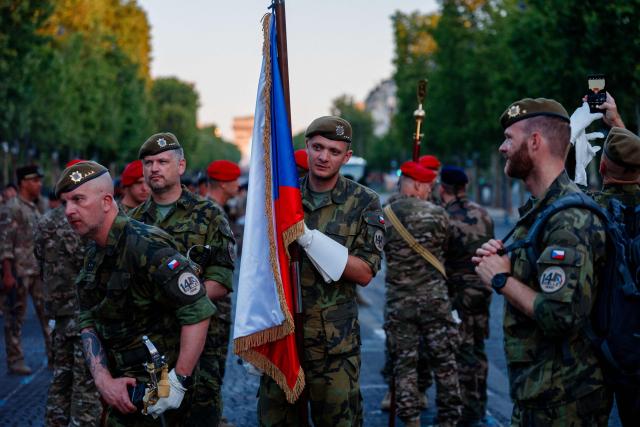 Czech Republic's army soldiers prepare to parade during a rehearsal of the annual Bastille Day military parade down the Champs Elysees Avenue, in Paris on July 8, 2026. (Photo by Dimitar DILKOFF / AFP)