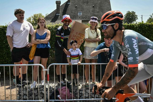 Spectators lining the race route watch as Netcompany INEOS team's Italian rider Filippo Ganna cycles past at the start of the 5th stage of the 113th edition of the Tour de France cycling race, 158 km between Lannemezan and Pau in southwestern France, on July 8, 2026. (Photo by Jeff PACHOUD / AFP)