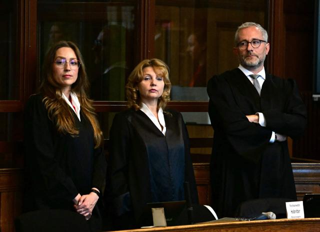 (FILES) The court-appointed defendant's lawyers, Klaudia Dawidowic (L-R), Ria Halbritter and Christoph Stoll wait for the start of the trial of a palliative care doctor allegedly accused of killing 15 patients with lethal injections, in the Regional Courtroom in Berlin, on July 14, 2025. A German palliative care doctor was sentenced to life in prison by a court in Berlin on July 8, 2026 for murdering 15 people with lethal doses of sedatives. (Photo by Tobias Schwarz / AFP)