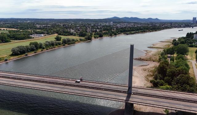 An aerial view shows the closed Bonn North Bridge on the A565 motorway in Bonn, western Germany on July 7, 2026. The dilapidated Bonn North Bridge (Friedrich-Ebert-Brücke) on the A565 has been completely closed to all motor traffic since June 2026. The approach bridge on the left bank of the Rhine has sustained extensive damage, will no longer be opened to traffic, and must be demolished and rebuilt. (Photo by Ina FASSBENDER / AFP)