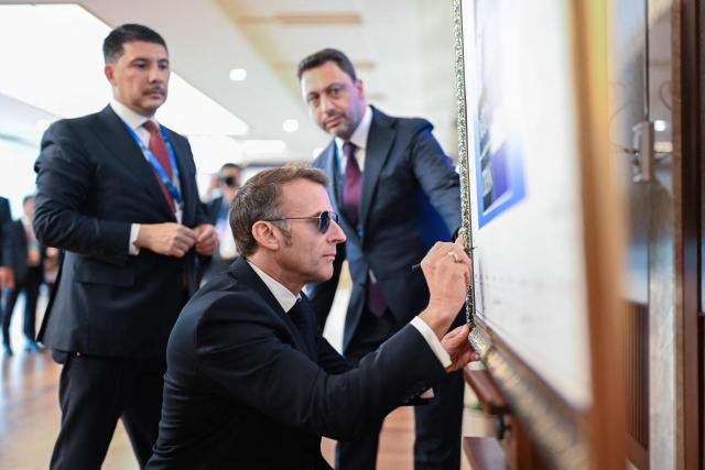 French President Emmanuel Macron signes a board within a bilateral meeting with Turkey's president on the sidelines of the 36th NATO Summit at Bestepe Presidential Compound in Ankara, Turkey, July 8, 2026. (Photo by Alexis JUMEAU / POOL / AFP)