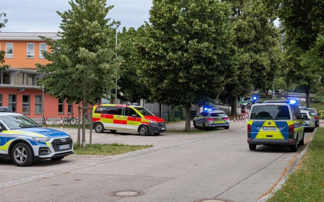 Cars by Police and rescue personnel are parked near the secondary school Schongau, in the southern German state of Bavaria, where  several people have been wounded and a suspect arrested in an attack on July 8, 2026. The perpetrator appeared to have deliberately targeted the school in a suspected "rampage", a police spokeswoman told AFP. (Photo by Christoph PETERS / DPA / AFP) / GERMANY OUT- GETTY OUT