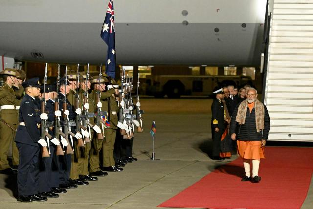 Indian Prime Minister Narendra Modi walks past the members of the armed forces upon his arrival at Melbourne International Airport in Melbourne on July 8, 2026, at the start of an official visit to Australia. (Photo by WILLIAM WEST / AFP)