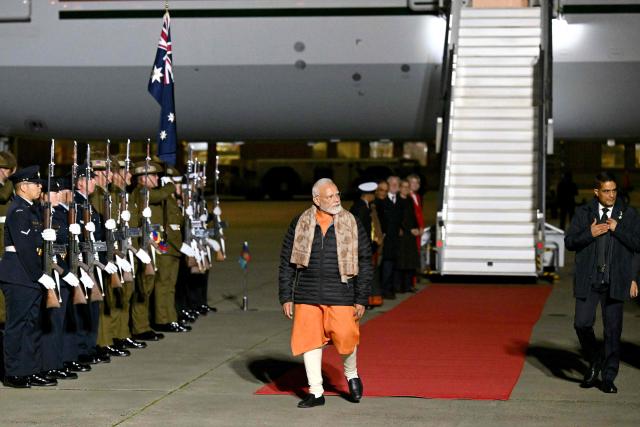 Indian Prime Minister Narendra Modi walks past the members of Australian armed forces upon his arrival at Melbourne International Airport in Melbourne on July 8, 2026, at the start of an official visit to Australia. (Photo by WILLIAM WEST / AFP)