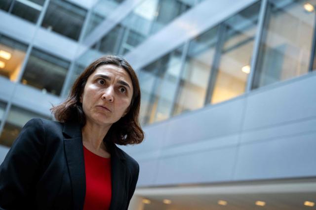 Deniz Igan, Division Chief in the International Monetary Fund (IMF)s Research Department speaks during an AFP interview at the IMF Headquarters in Washington, DC, on July 7, 2026. The IMF on July 8, 2026, cut its 2026 growth projection for the world economy again, saying an AI boom has not fully offset the fallout from war in the Middle East. Deniz Igan, division chief at the IMF's research department, told AFP that its forecasts are "broadly unchanged" cumulatively for the next two years and described the bounceback as "a V-shaped recovery." The delayed recovery from war on Iran, longer disruptions and higher prices is part of the reason the world economy will take a bigger hit this year, she added. (Photo by Kent Nishimura / AFP)