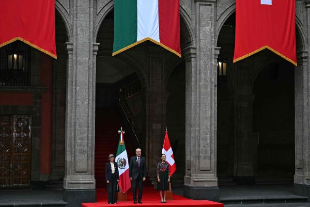 Mexico's President Claudia Sheinbaum (R) poses with Guy Parmelin (C), President of the Swiss Confederation and Minister of Economy, and his wife, Caroline Merotto, at National Palace in Mexico City on July 8, 2026. (Photo by YURI CORTEZ / AFP)