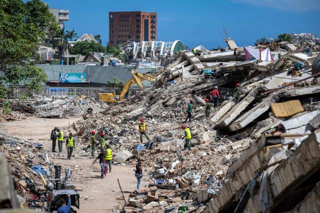 A rescue team works in the ruins of a building destroyed by the June 24 earthquakes in Caraballeda, La Guaira state, Venezuela, on July 8, 2026. Venezuela's government called on July 8, 2026 for the release of frozen assets to help raise funds for the country's recovery from last month's twin earthquakes that killed at least 3,600 people. (Photo by Miguel MEDINA / AFP)