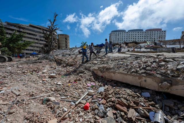 Locals work ammid the rubble of a building destroyed by the June 24 earthquakes in Caraballeda, La Guaira state, Venezuela, on July 8, 2026. Venezuela's government called on July 8, 2026 for the release of frozen assets to help raise funds for the country's recovery from last month's twin earthquakes that killed at least 3,600 people. (Photo by Miguel MEDINA / AFP)