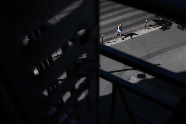 A man walks in Paris on July 8, 2026, as France experiences a heatwave. (Photo by JOEL SAGET / AFP)