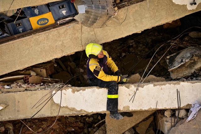 A Venezuelan rescue worker searches for victims in a destroyed building in Caraballeda, La Guaira state, Venezuela, on July 8, 2026, after the June 24 earthquakes. Venezuela's government called on July 8, 2026 for the release of frozen assets to help raise funds for the country's recovery from last month's twin earthquakes that killed at least 3,600 people. (Photo by MARTIN BERNETTI / AFP)