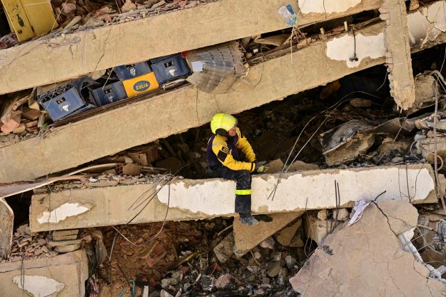 A Venezuelan rescue worker searches for victims in a destroyed building in Caraballeda, La Guaira state, Venezuela, on July 8, 2026, after the June 24 earthquakes. Venezuela's government called on July 8, 2026 for the release of frozen assets to help raise funds for the country's recovery from last month's twin earthquakes that killed at least 3,600 people. (Photo by MARTIN BERNETTI / AFP)