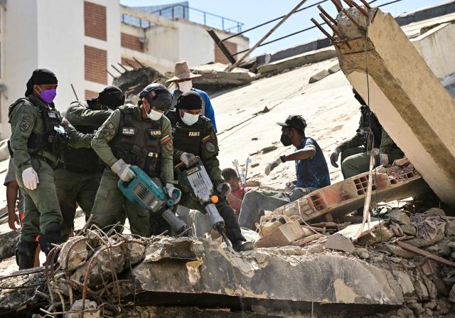 A Venezuelan rescue team works in a destroyed building in Caraballeda, La Guaira state, Venezuela, on July 8, 2026, after the June 24 earthquakes. Venezuela's government called on July 8, 2026 for the release of frozen assets to help raise funds for the country's recovery from last month's twin earthquakes that killed at least 3,600 people. (Photo by MARTIN BERNETTI / AFP)