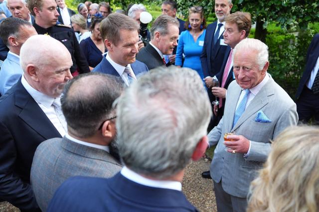 Britain's King Charles III (R) speaks to guests during a reception for recipients of the King's Award for Enterprise 2026 at St James's Palace in London on July 8, 2026. (Photo by Aaron Chown / POOL / AFP)