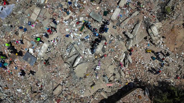 This aerial picture shows people working on the ruins of buildings destroyed by the June 24 earthquakes in Caraballeda, La Guaira state, Venezuela, on July 8, 2026. Venezuela's government called on July 8, 2026 for the release of frozen assets to help raise funds for the country's recovery from last month's twin earthquakes that killed at least 3,600 people. (Photo by Miguel MEDINA / AFP)